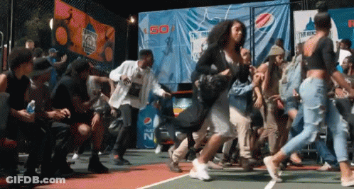 A Group Of People Are Dancing On A Court In Front Of A Pepsi Banner . GIF