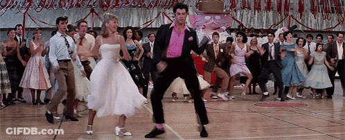 A Group Of People Are Dancing On A Dance Floor In A Gym . GIF