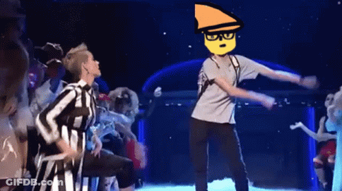 A Group Of People Are Dancing On A Stage And One Of Them Has A Yellow Face On His Head . GIF