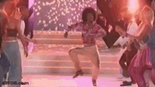 A Group Of People Are Dancing On A Stage In A Disco . GIF