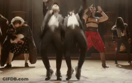 A Group Of People Are Dancing On A Stage In A Theater . GIF