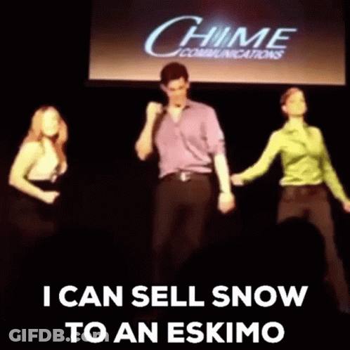 A Group Of People Are Dancing On A Stage In Front Of A Chime Communications Sign . GIF