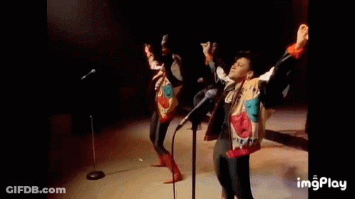 A Group Of People Are Dancing On A Stage In Front Of A Crowd . GIF