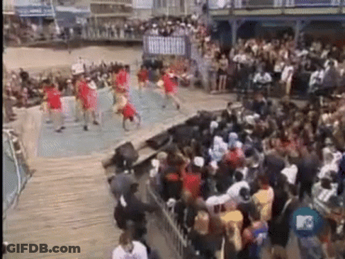 A Group Of People Are Dancing On A Stage In Front Of A Crowd Of People . GIF
