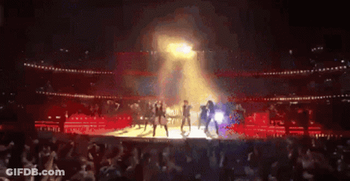 Group Dancing On Stage In Front Of Crowd GIF