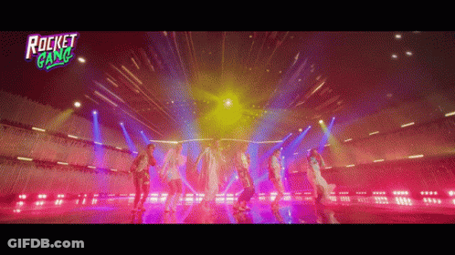A Group Of People Are Dancing On A Stage With A Rocket Gang Logo GIF