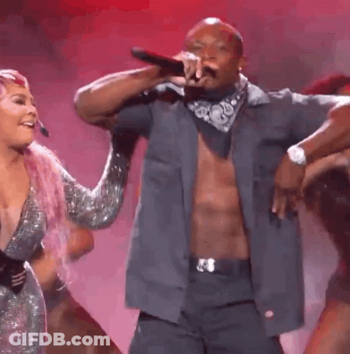 A Group Of People Are Dancing On A Stage With The Number 1 In The Middle GIF