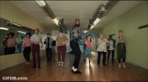 A Group Of People Are Dancing Together In A Room GIF