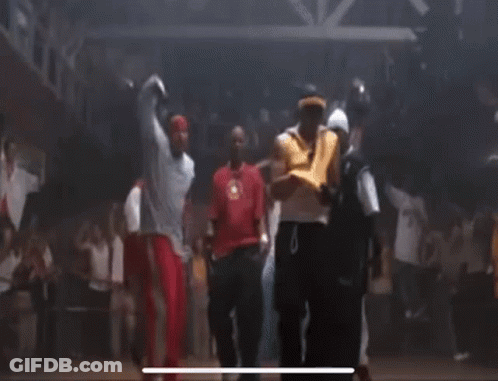 A Group Of People Are Dancing Together On A Dance Floor In A Dark Room . GIF