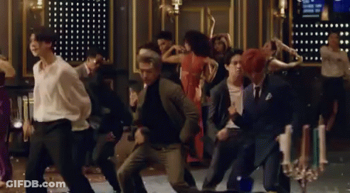 A Group Of People Are Dancing Together On A Dance Floor In A Room . GIF