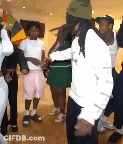 A Group Of People Are Dancing Together On A Dance Floor In A Room . GIF