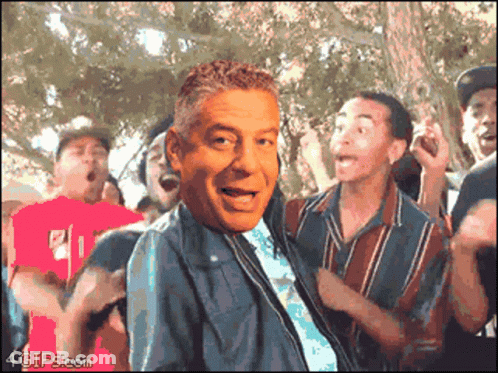 A Group Of People Are Dancing With A Man 'S Face In The Foreground And 4Gifs.com In The Bottom Right Corner GIF