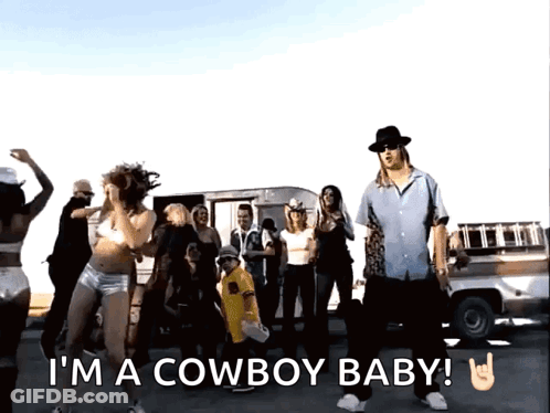 A Group Of People Are Dancing With The Words I 'M A Cowboy Baby Written Below Them GIF