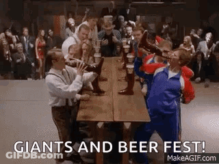A Group Of People Are Drinking Beer At A Long Table . GIF