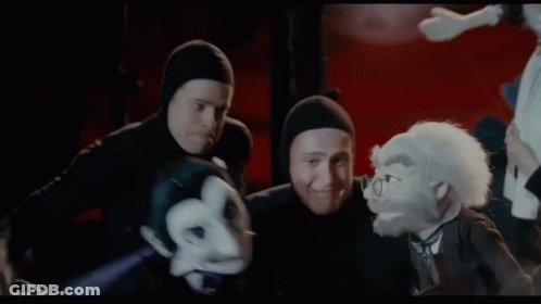 A Group Of People Are Fighting Each Other In A Dark Room . GIF