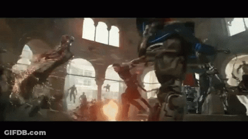 A Group Of People Are Fighting Each Other In A Room With A Fire Coming Out Of The Ceiling . GIF