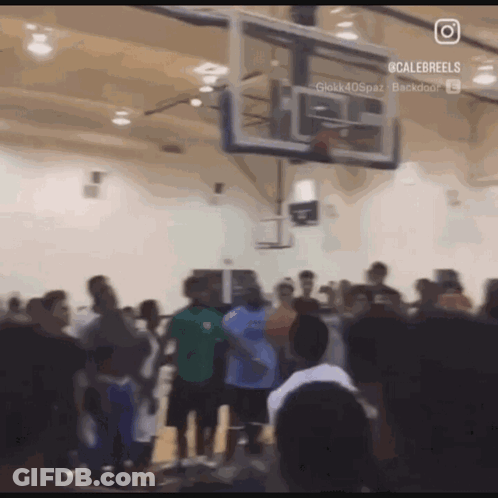 A Group Of People Are Gathered Around A Basketball Hoop With A Caption That Says Calebreels On It GIF