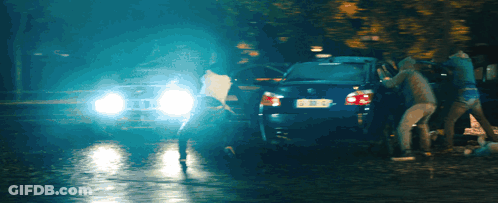 A Group Of People Are Gathered Around A Car With A License Plate That Says Bbc GIF