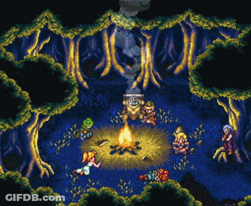 A Group Of People Are Gathered Around A Fire In The Middle Of A Forest GIF
