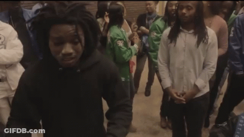 A Group Of People Are Gathered Around A Young Man In A Black Hoodie GIF