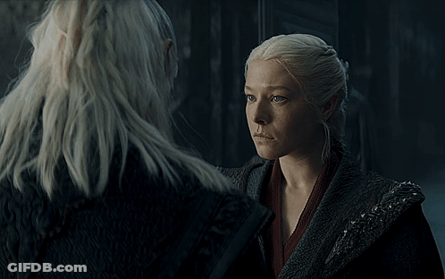 A Group Of People Are Gathered In A Dark Room With A Castle In The Background GIF
