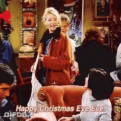 A Group Of People Are Gathered In A Living Room And One Of Them Says " Happy Christmas Eve Eve " GIF