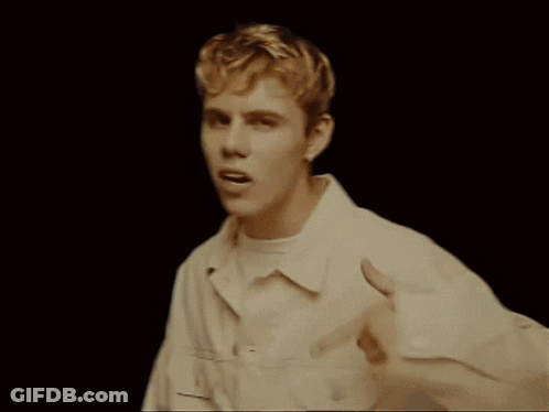 A Group Of People Are Gathered In A Living Room Including A Boy And A Girl GIF