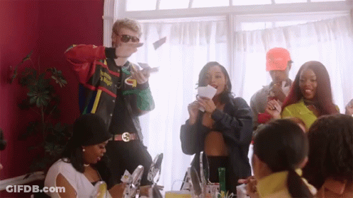 A Group Of People Are Gathered In A Room And One Of Them Is Wearing A Jacket That Says Supreme On It GIF