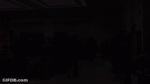 A Group Of People Are Gathered In A Room With Hulk Posters On The Floor GIF