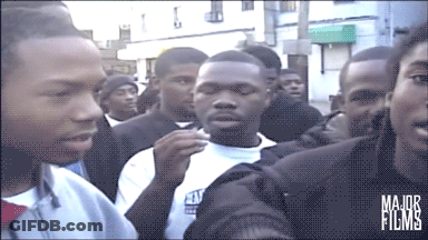 A Group Of People Are Gathered In Front Of A Building That Says Major Films On The Bottom GIF