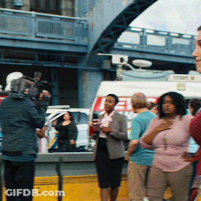 A Group Of People Are Gathered In Front Of A Van That Says ' Ee ' On It GIF