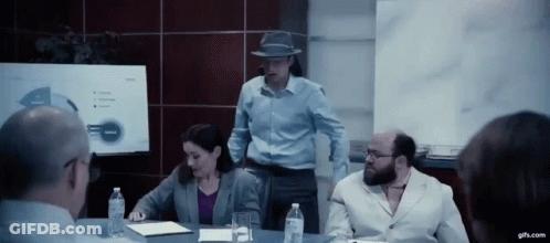 A Group Of People Are Having A Meeting In A Conference Room GIF