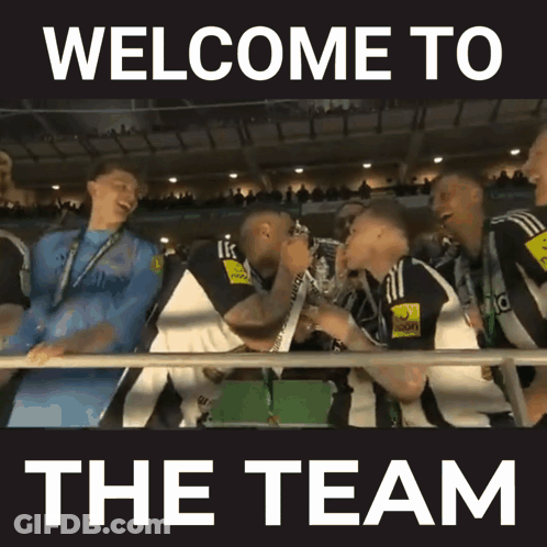A Group Of People Are Holding Up A Trophy With The Words Welcome To The Team Below Them GIF