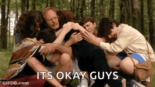 A Group Of People Are Hugging Each Other In A Circle . GIF