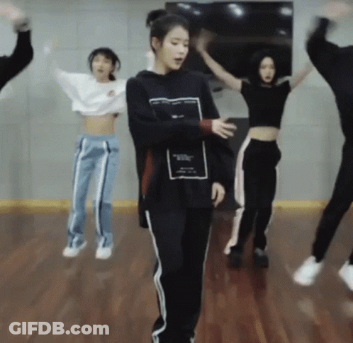 A Group Of People Are Jumping In The Air While Dancing In A Dance Studio . GIF
