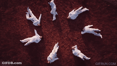 A Group Of People Are Laying In A Circle With The Website Gifrun.com In The Corner GIF