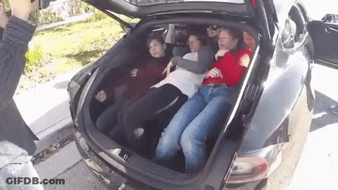 A Group Of People Are Laying In The Back Of A Car GIF