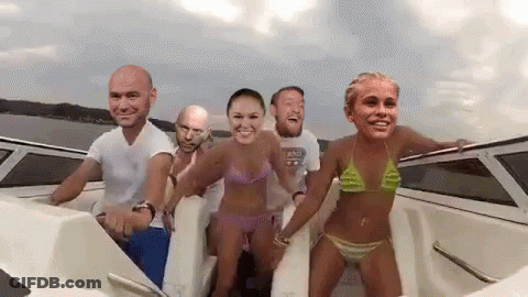 A Group Of People Are On A Boat With Their Faces On The Side . GIF