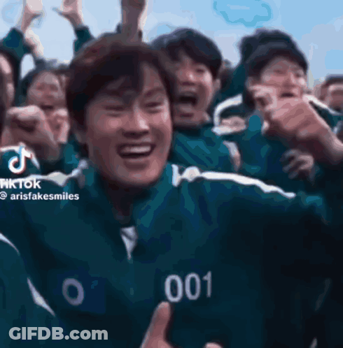 A Group Of People Are Playing A Game Called Squid Game And One Of Them Is Wearing A Number 001 Jacket . GIF