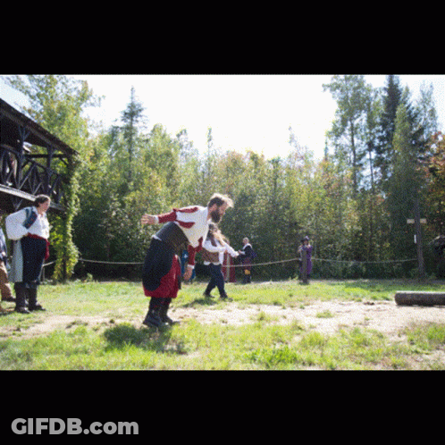 A Group Of People Are Playing A Game In A Grassy Field GIF