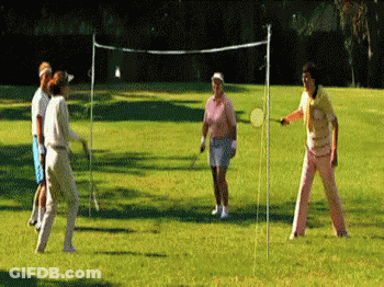 A Group Of People Are Playing A Game Of Badminton On A Lush Green Field GIF