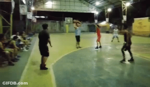 A Group Of People Are Playing A Game Of Basketball On A Court With A Sign That Says ' Coca-Cola ' GIF