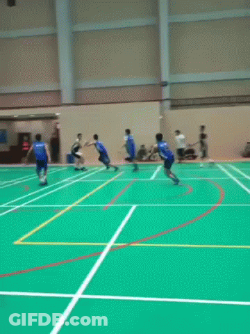 A Group Of People Are Playing A Game Of Basketball On A Court . GIF