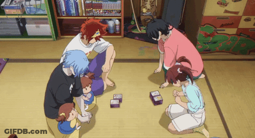 A Group Of People Are Playing A Game Of Cards In A Room GIF
