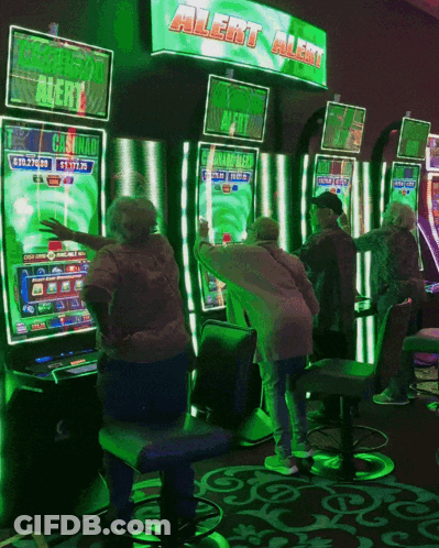 A Group Of People Are Playing A Slot Machine Under A Green Sign That Says Alert Alert GIF