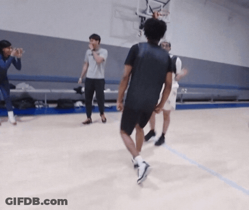 A Group Of People Are Playing Basketball On A Court And One Of Them Is Wearing A Black Shirt GIF