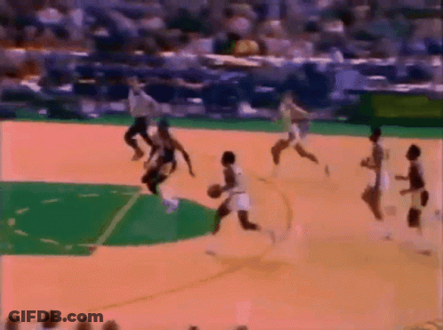 A Group Of People Are Playing Basketball On A Court With A Referee In The Background GIF