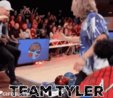 A Group Of People Are Playing Bowling In Front Of A Crowd And The Words Team Tyler Are Written On The Floor . GIF