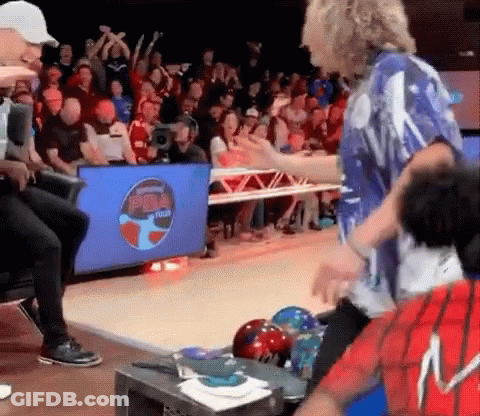 A Group Of People Are Playing Bowling In Front Of A Screen That Says Bowl Tech GIF