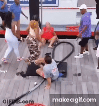 A Group Of People Are Playing With A Vacuum Cleaner On A Wooden Floor . GIF
